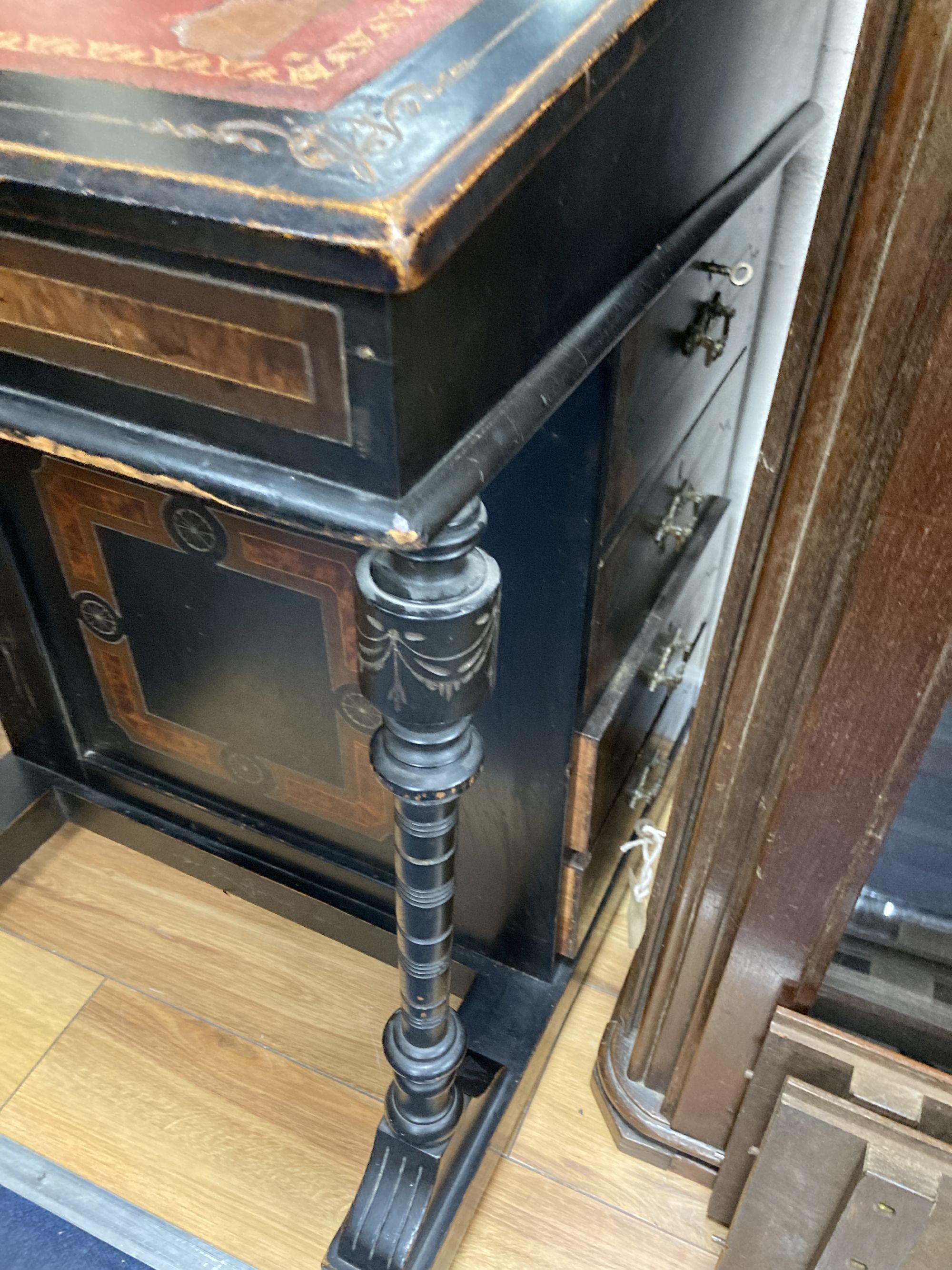 A late Victorian ebonised and amboyna Davenport, width 55cm, depth 56cm, height 86cm